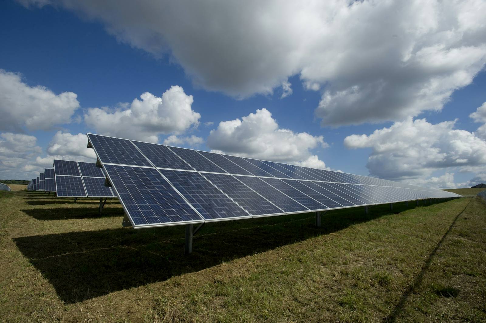 A ground-mounted solar array running out across open ground
