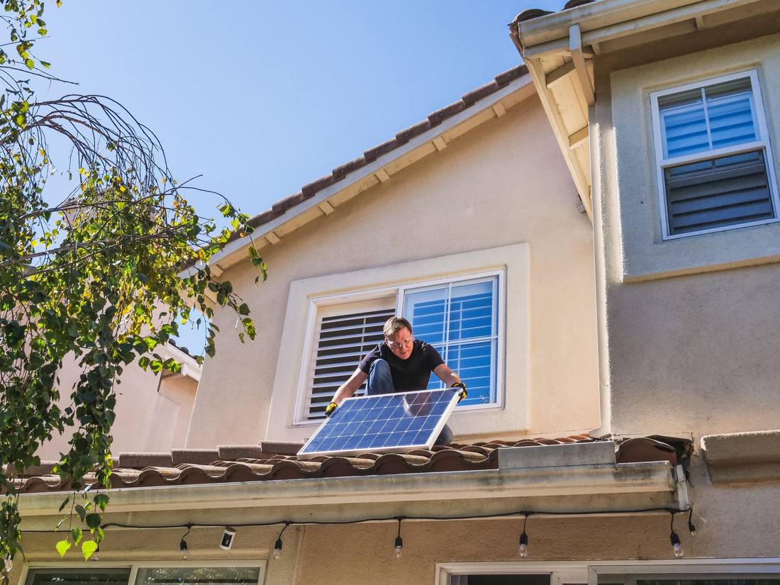 An engineer inspecting a rooftop solar installation