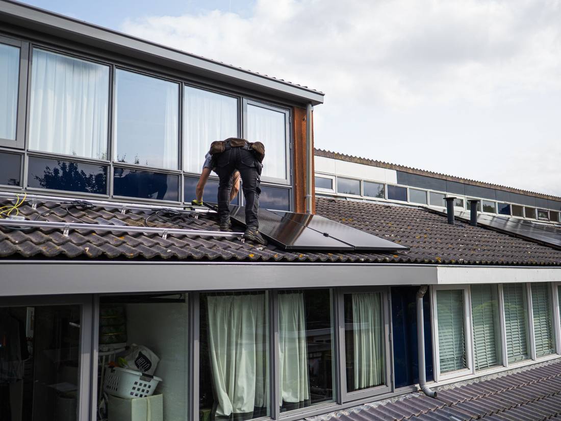 An engineer working on a rooftop solar installation