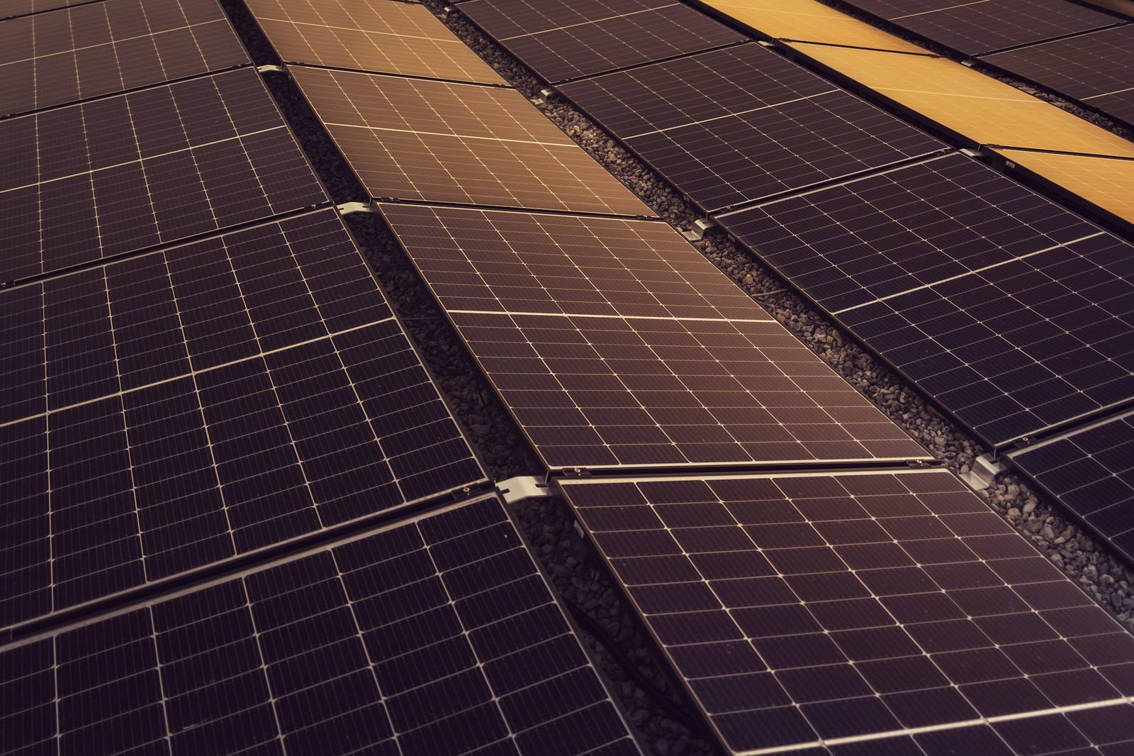Rows of solar modules across a large rooftop installation